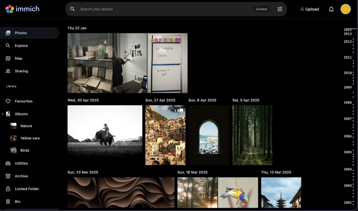Immich photo timeline for a self-hosted photo library Immich photo timeline showing a self-hosted library with dated photo groups, albums, and search